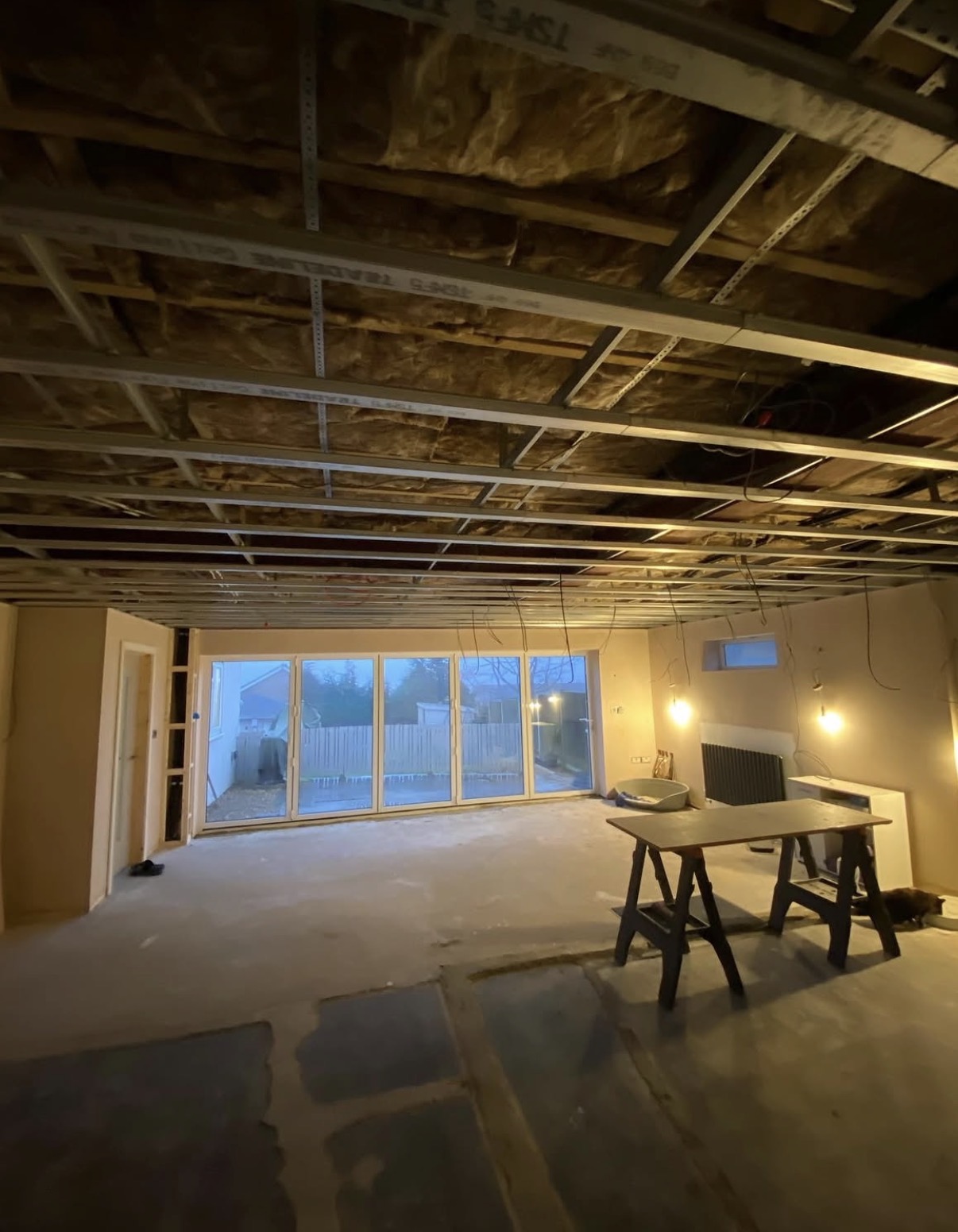 Metal ceiling framework installed across an open-plan room ready for plasterboarding